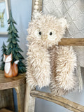 A fluffy owl lovey made by ClaraLoo with plush tan faux fur and crocheted accents.