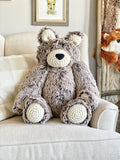 A large plush bear stuffed animal made by ClaraLoo with soft brown frosted faux fur and crocheted accents.